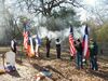 Texas Ranger reenactors fire a salute to Mr. Anglin, with the Children of the Republic of Texas Color Guard (Cash Moser and Hayden Roberts) Observing.